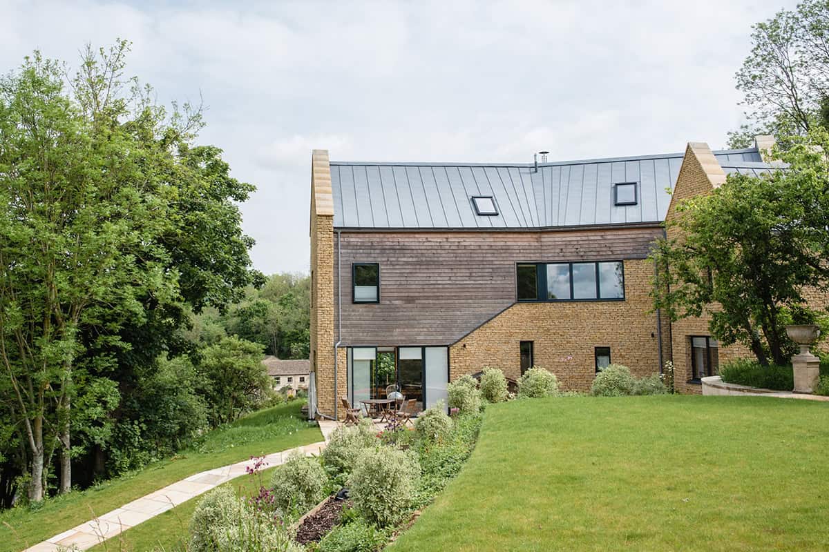 Harleywood House garden elevation with timber cladding, glazed doors and valley views